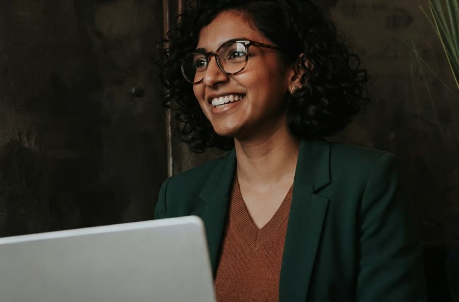 A team member smiling during a video-based practice session on a laptop